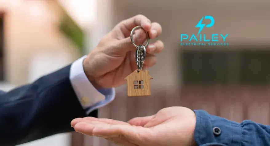 Photo of landlord handing over house keys to a tenant